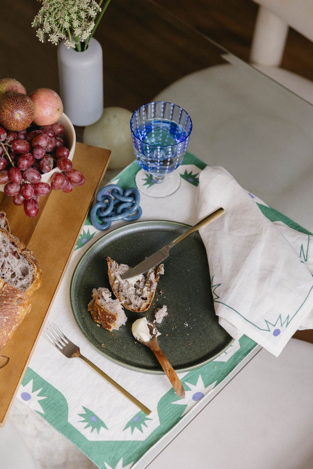 Blue napkin ring on a table setting with matching linen placemat and dinner napkin.