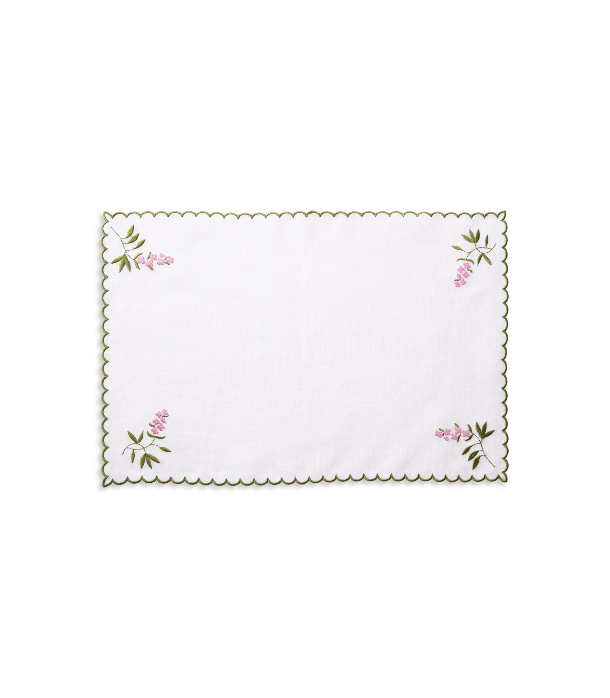 White linen placemat with green scallop edge embroidery and lavender corner motifs